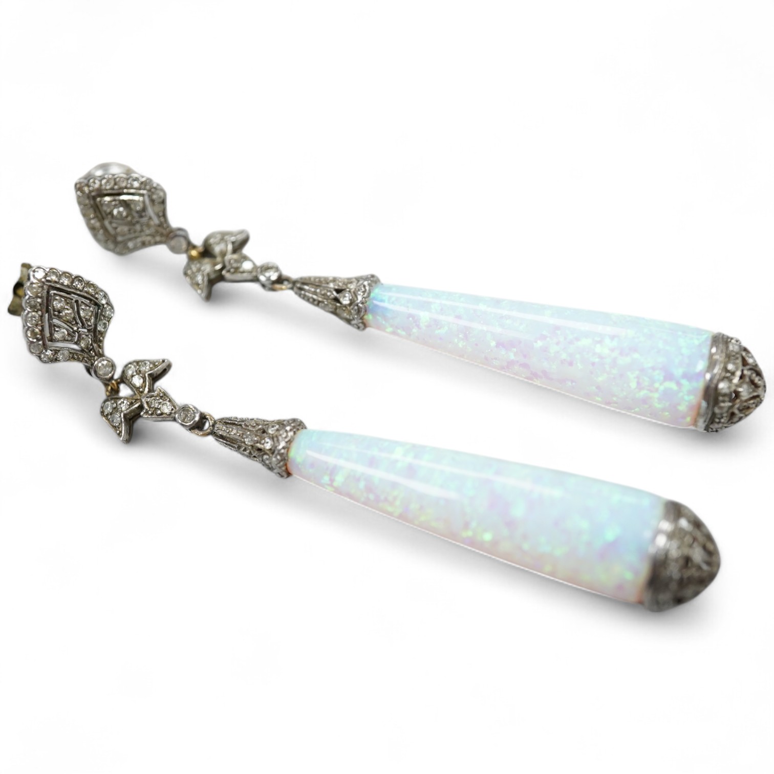 A pair of 1920's style white metal, synthetic opal and diamond chip set drop earrings, 63mm, gross weight 8.2 grams.